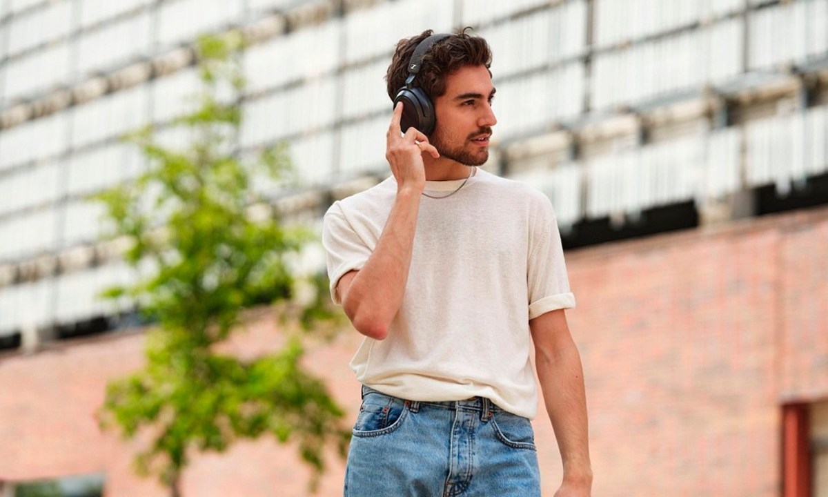 Listening to the Sennheiser Momentum 4 headphones in public.