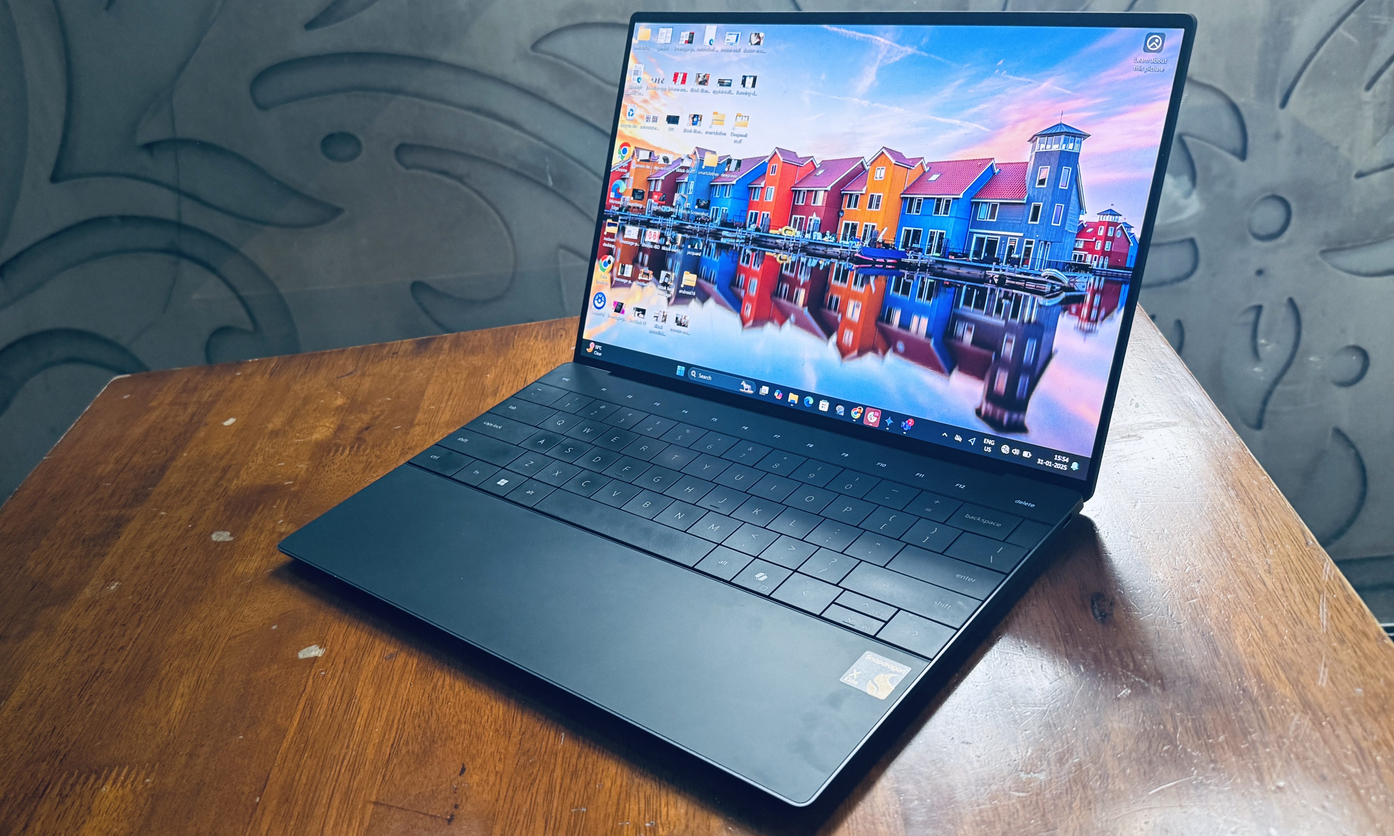 Angled front view of the Dell XPS 13 with Snapdragon X Elite processor inside.